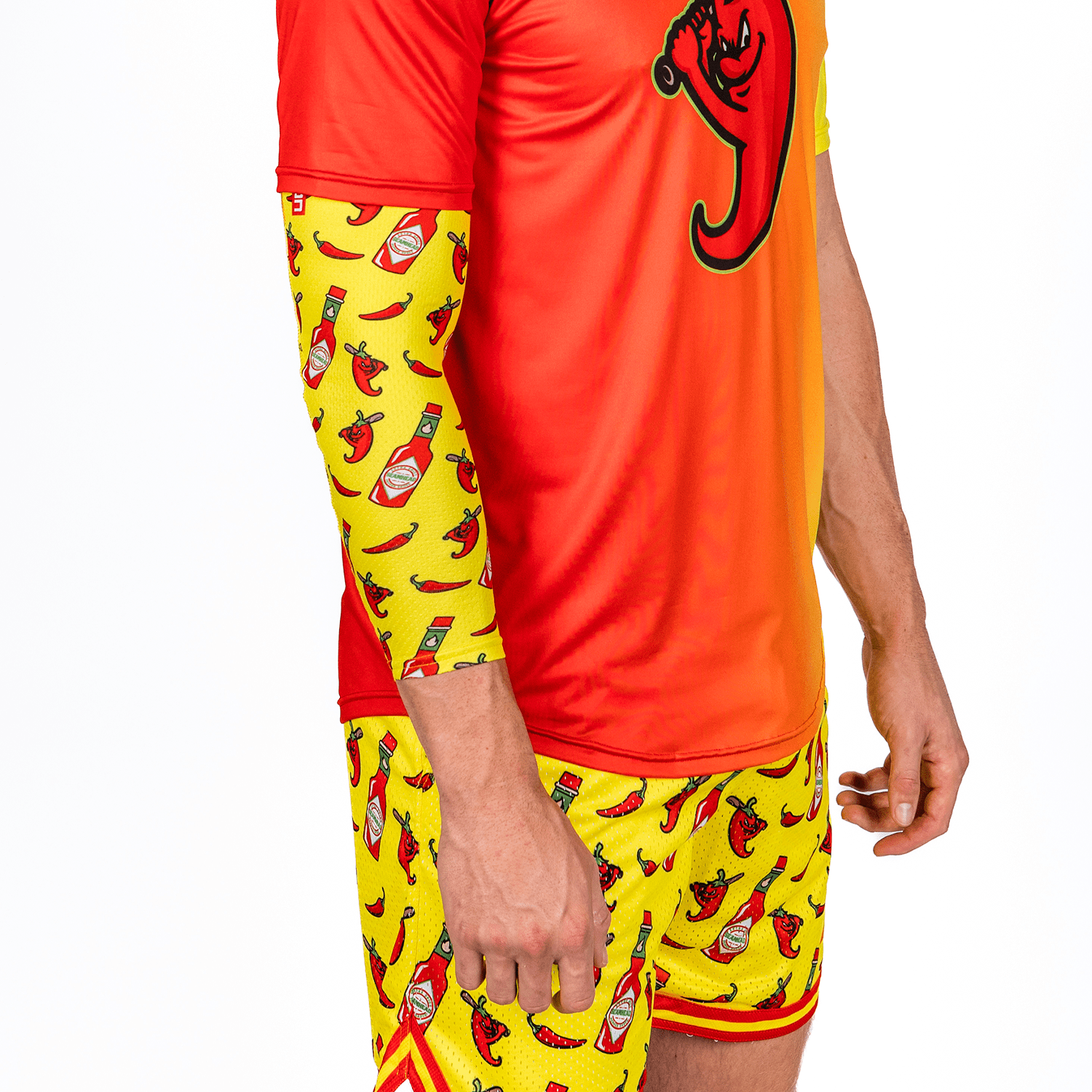 Person wearing a red and yellow outfit with hot pepper and ketchup pattern on a white background