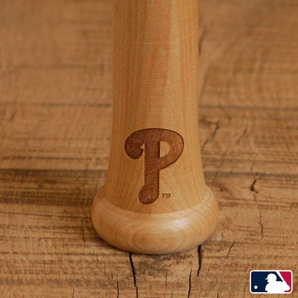 Wooden baseball bat with a logo on a wooden background