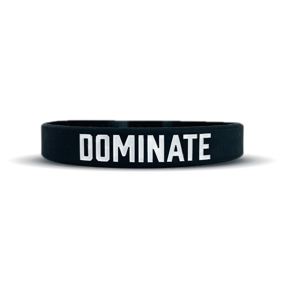 Black wristband with 'DOMINATE' text on a white background
