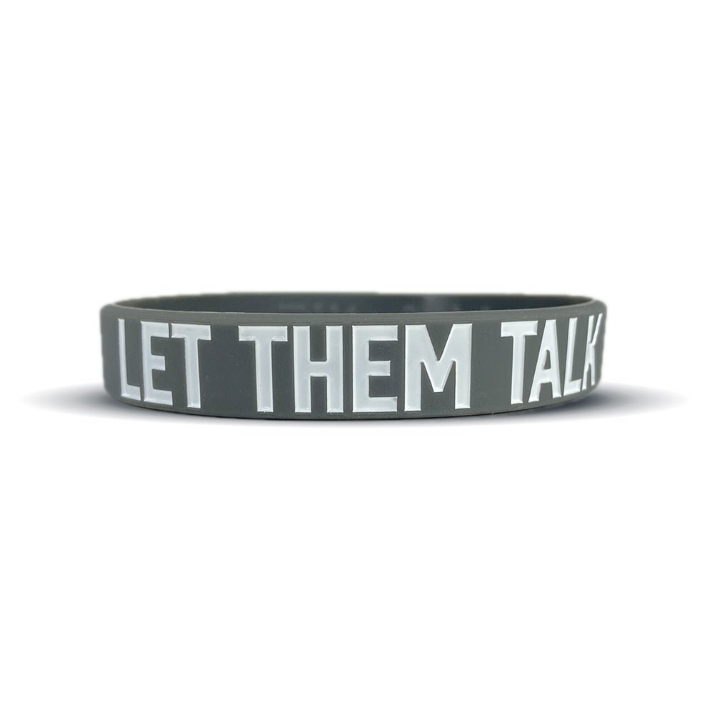 Gray wristband with 'LET THEM TALK!' text on a white background