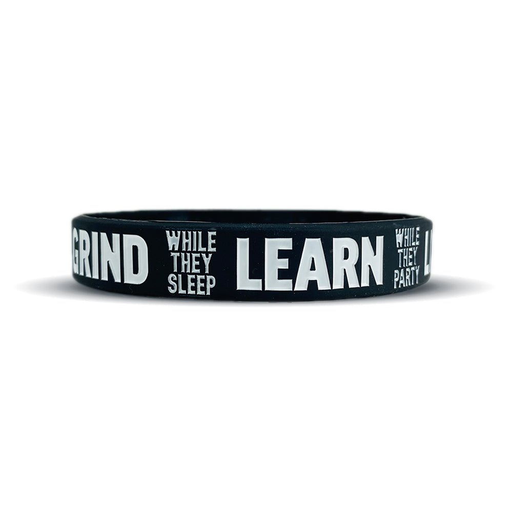 Black wristband with white text on a white background