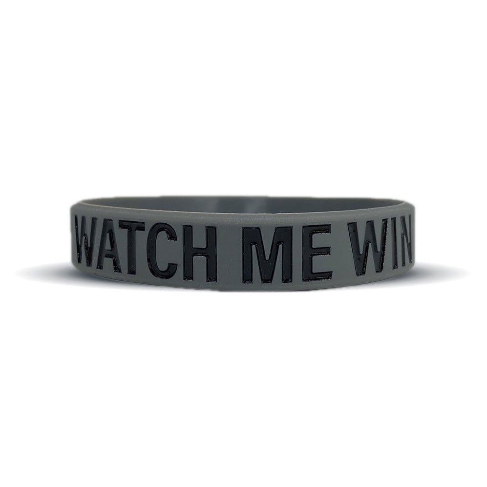 Black wristband with 'WATCH ME WIN' text on a white background