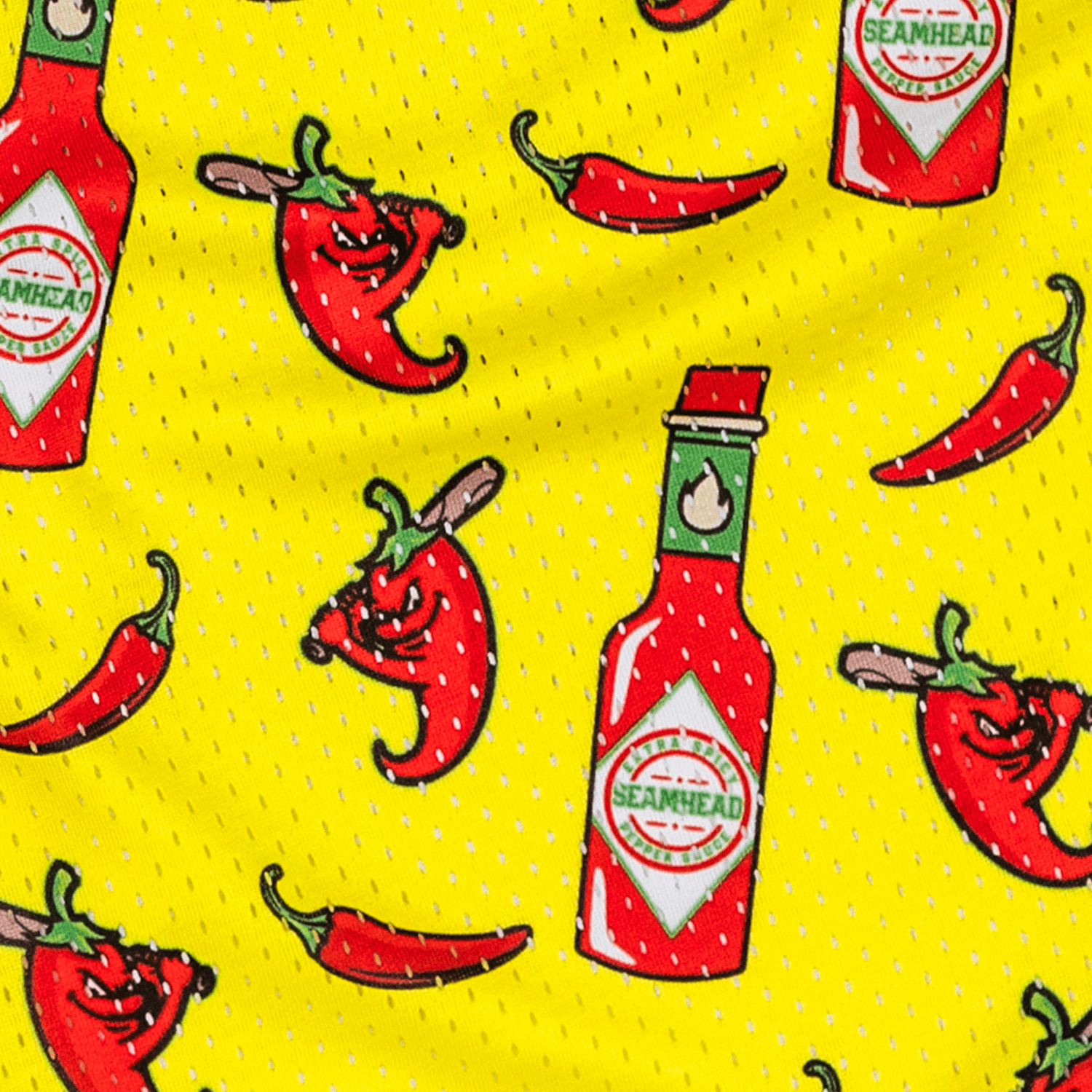 Collection of Pattern of red hot sauce bottles and red peppers on a yellow athletic youth shorts in a gallery layout