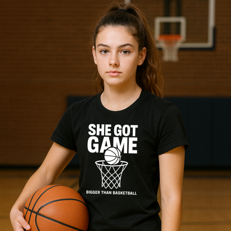 Collection of Girl wearing a black t-shirt with 'She Got Game' text holding a basketball in a gym. in a gallery layout