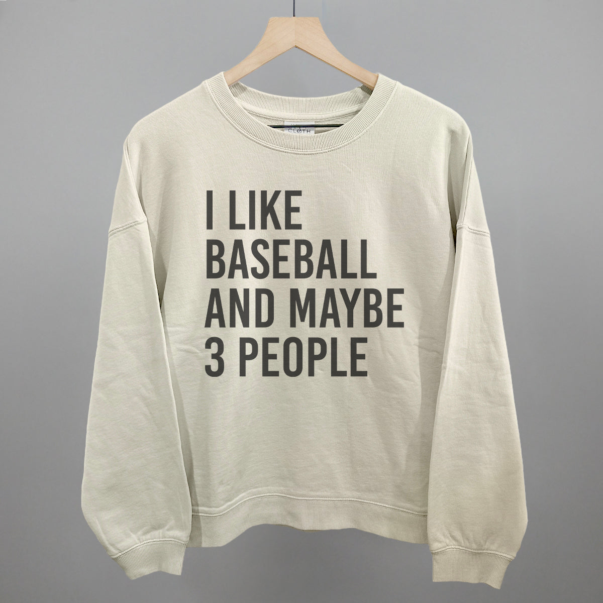 Bone sweatshirt with text 'I LIKE BASEBALL AND MAYBE 3 PEOPLE' on a gray background