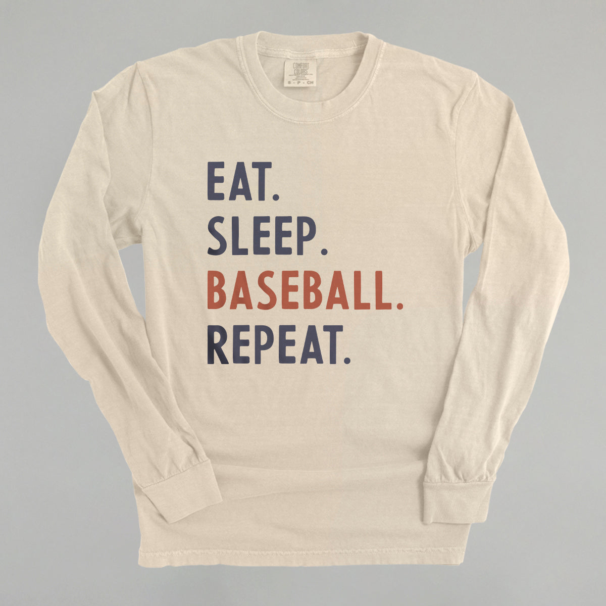 Collection of Beige long-sleeve shirt with 'Eat. Sleep. Baseball. Repeat.' text on a gray background in a gallery layout