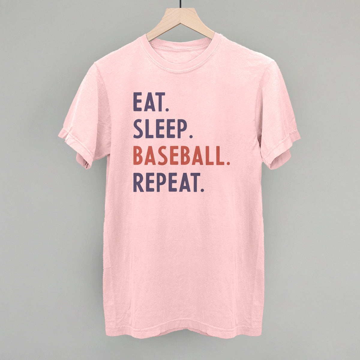 Collection of Pink t-shirt with 'Eat. Sleep. Baseball. Repeat.' text on a gray background in a gallery layout