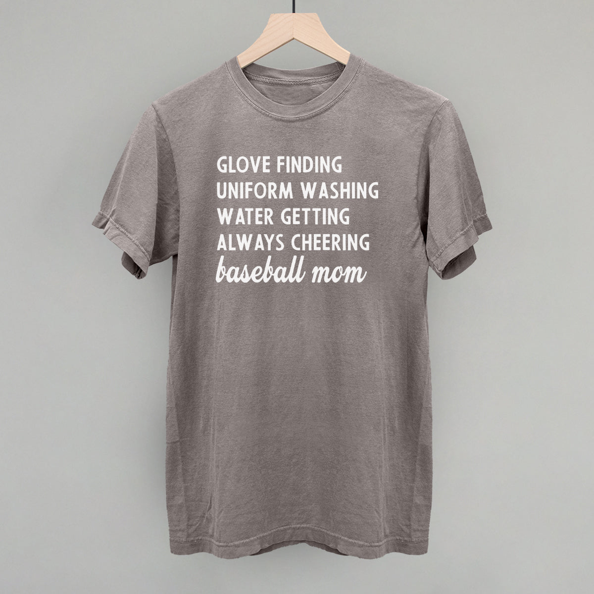 Collection of Gray comfort color t-shirt with white text on a wooden hanger against a gray background in a gallery layout