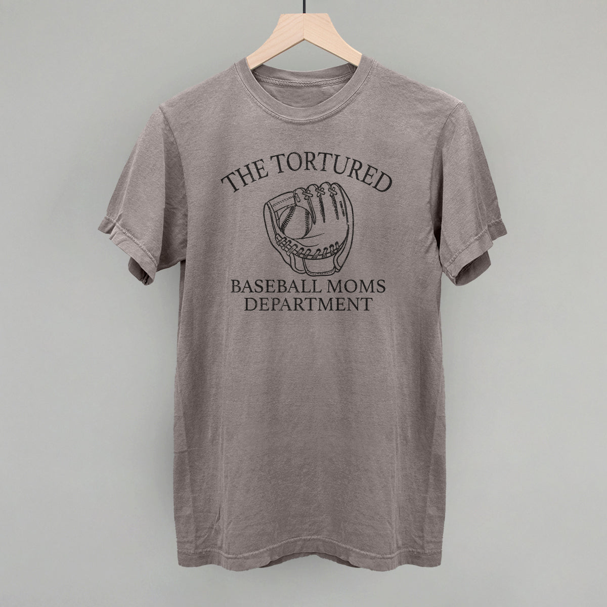 Gray t-shirt with 'The Tortured Baseball Moms Department' text and graphic on a hanger against a gray background