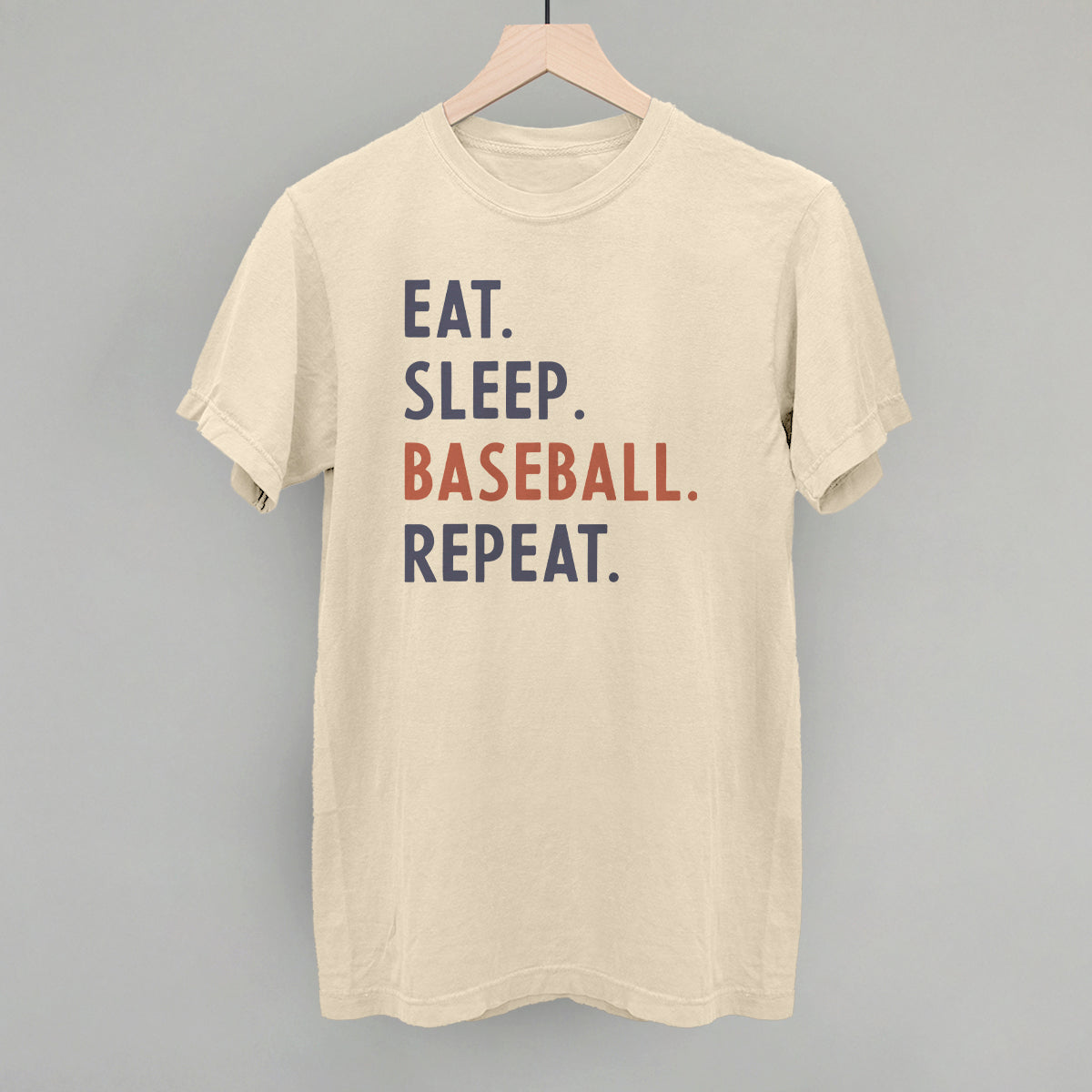 Collection of Beige t-shirt with 'Eat. Sleep. Baseball. Repeat.' text on a gray background in a gallery layout