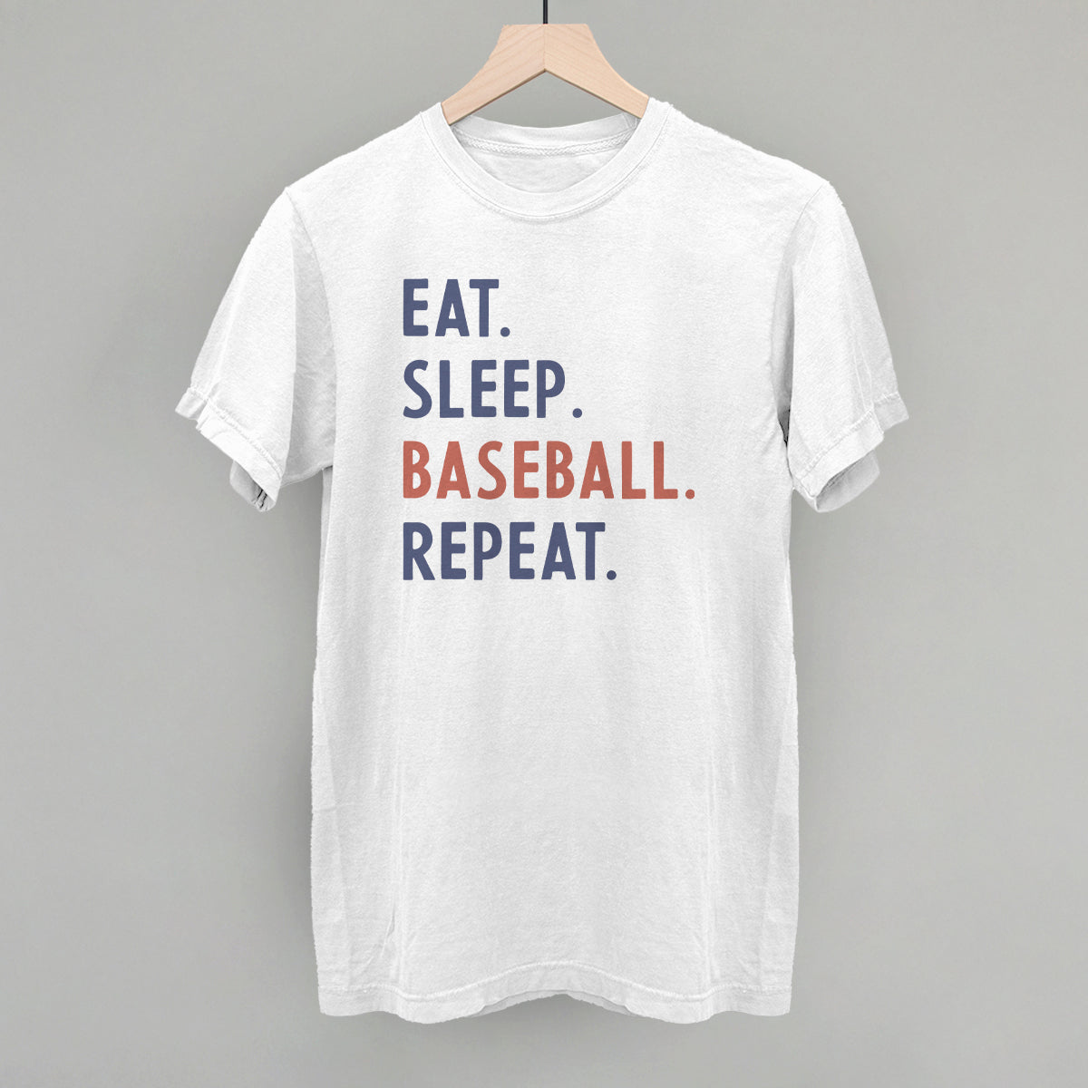 White t-shirt with 'Eat. Sleep. Baseball. Repeat.' text on a gray background