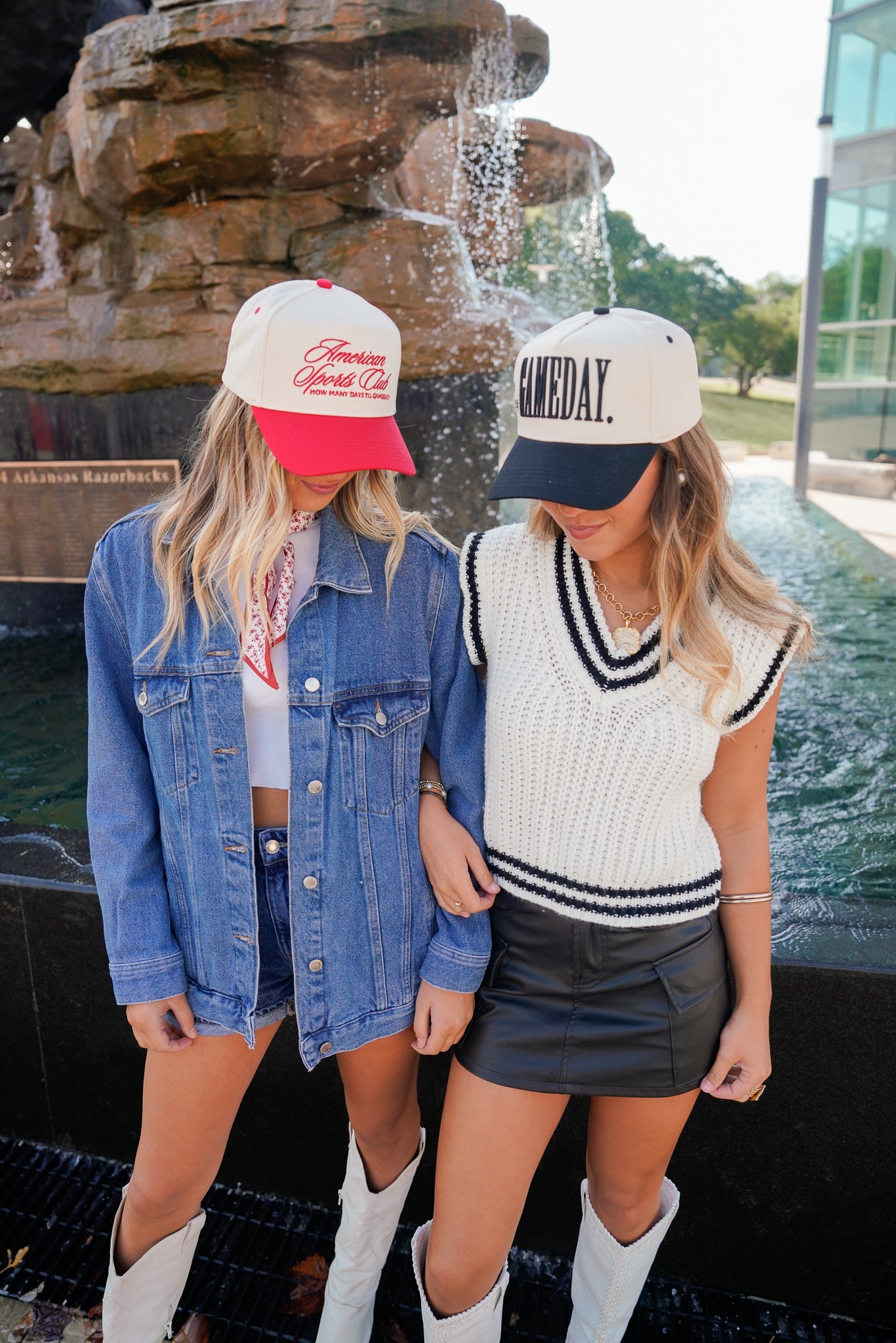 Collection of Two women standing in front of a fountain, wearing casual outfits with hats. in a gallery layout
