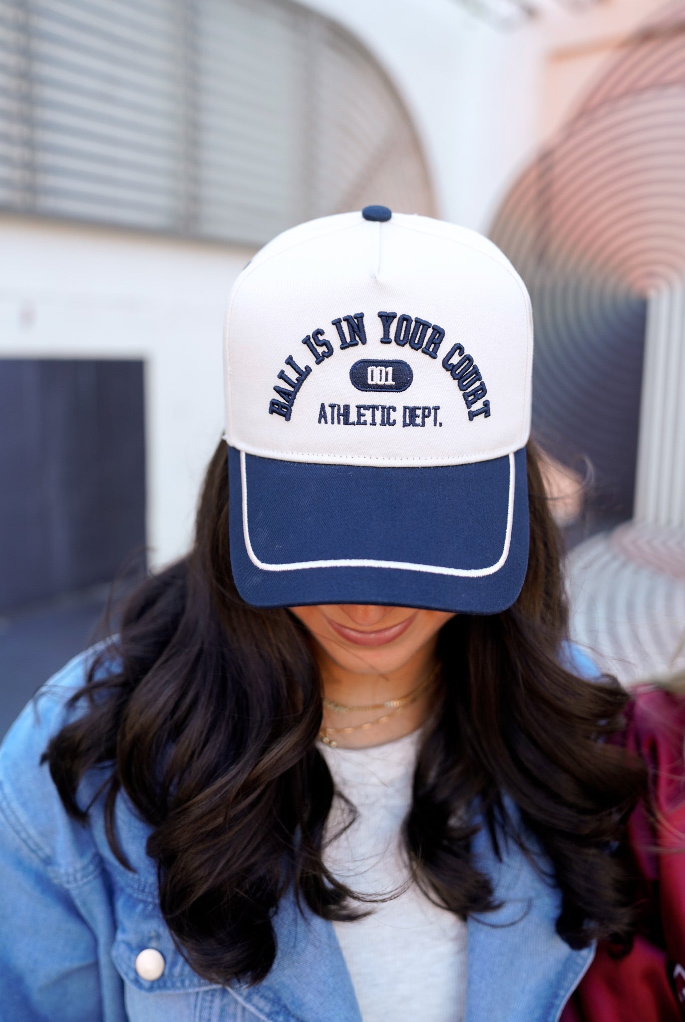 Collection of Person wearing a white and blue cap with text, blurred background in a gallery layout
