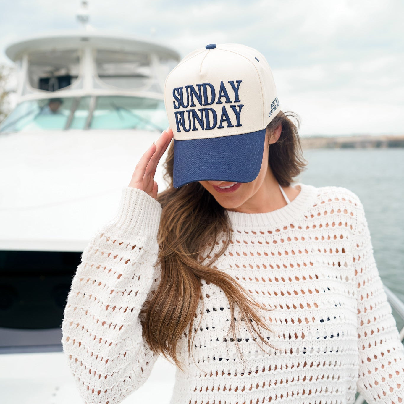 Collection of Woman wearing a 'Sunday Funday' cap on a boat in a gallery layout