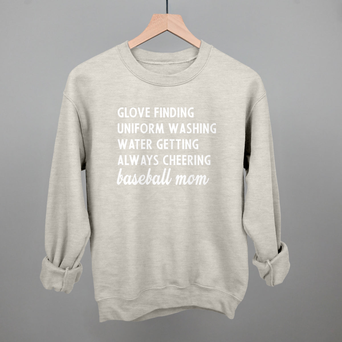 Collection of Gray comfort color sweatshirt with white text on a hanger against a gray background in a gallery layout