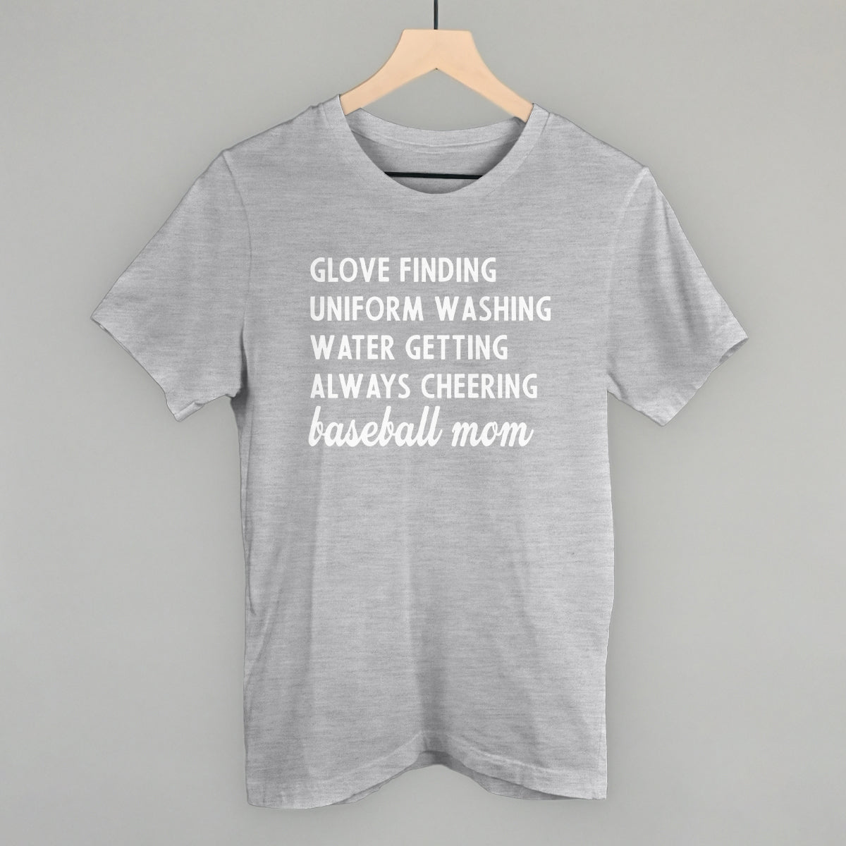 Gray comfort color t-shirt with white text on a hanger against a gray background
