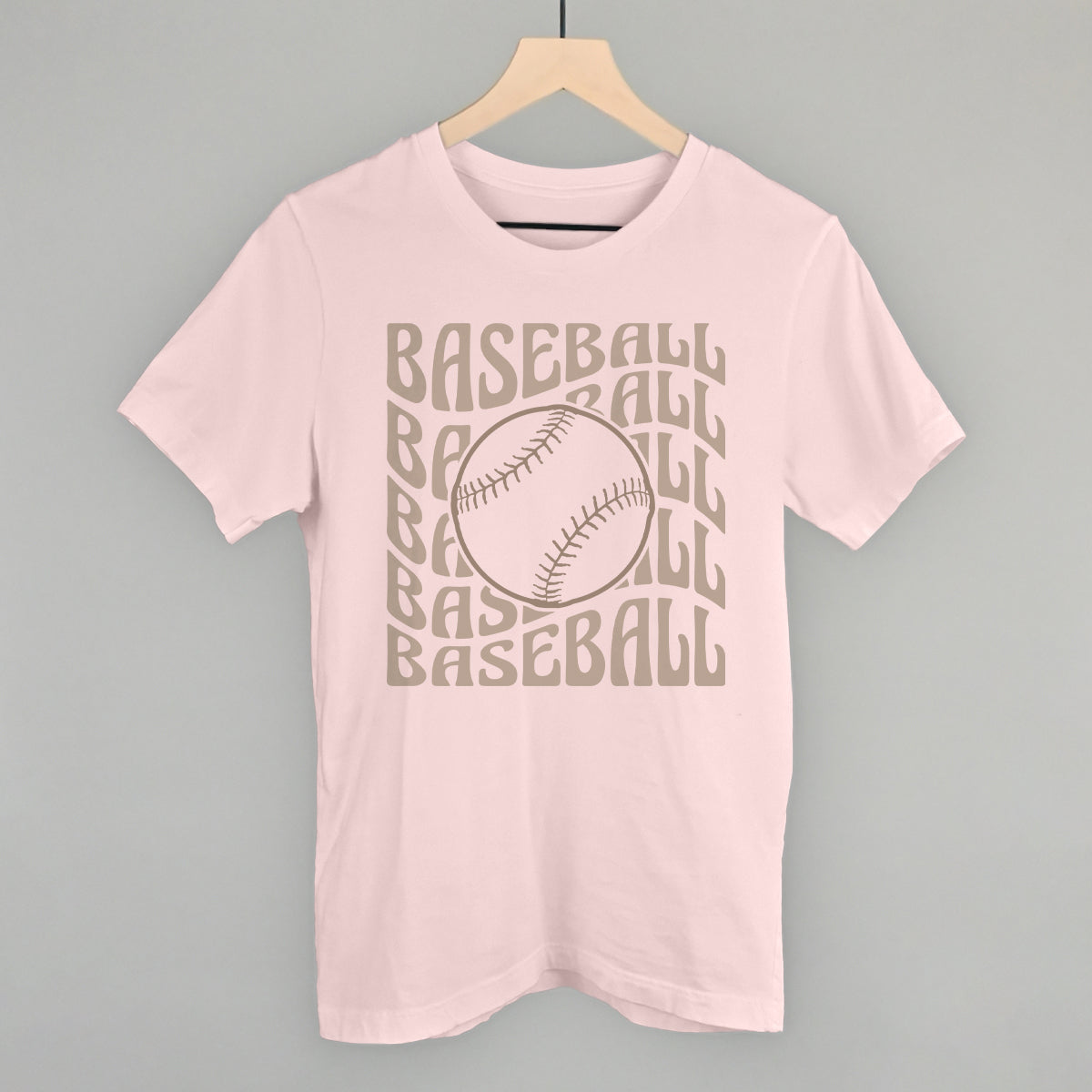 Collection of Pink t-shirt with 'BASEBALL' text and baseball graphic on a hanger against a gray background in a gallery layout