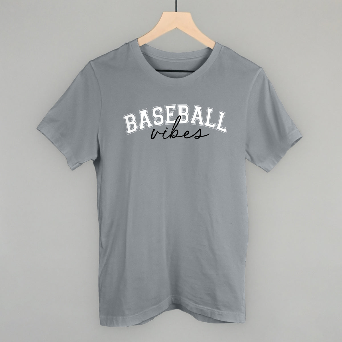 Collection of Gray t-shirt with 'BASEBALL vibes' text on a hanger against a gray background in a gallery layout