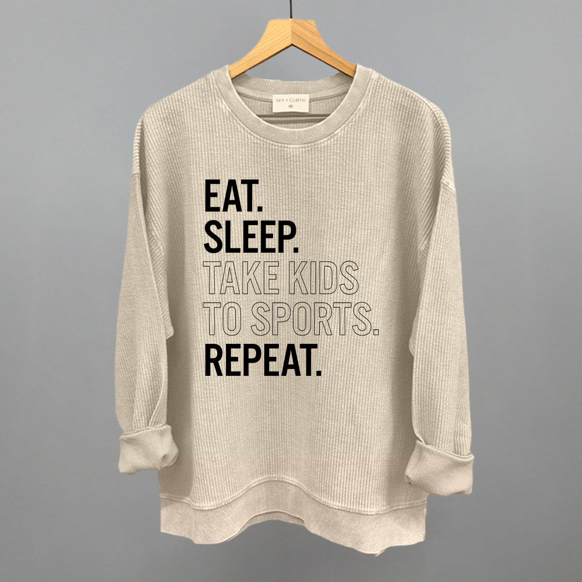 Collection of moonbeam comfort colors corded crew sweatshirt with text on a hanger against a gray background in a gallery layout