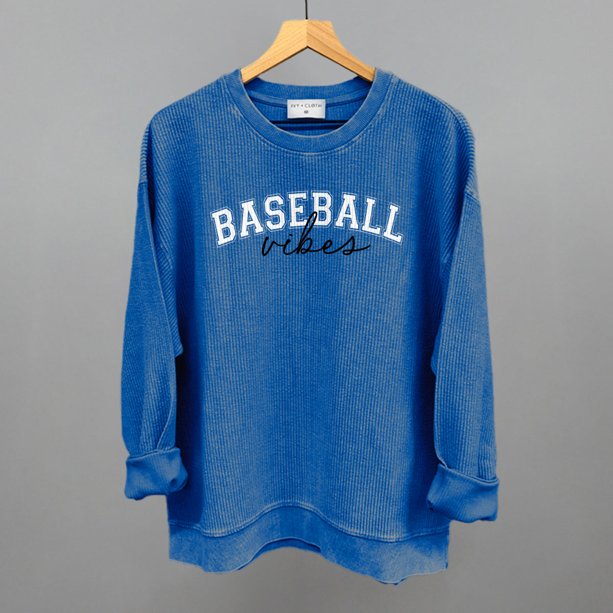 Blue sweatshirt with 'BASEBALL vibes' text on a gray background