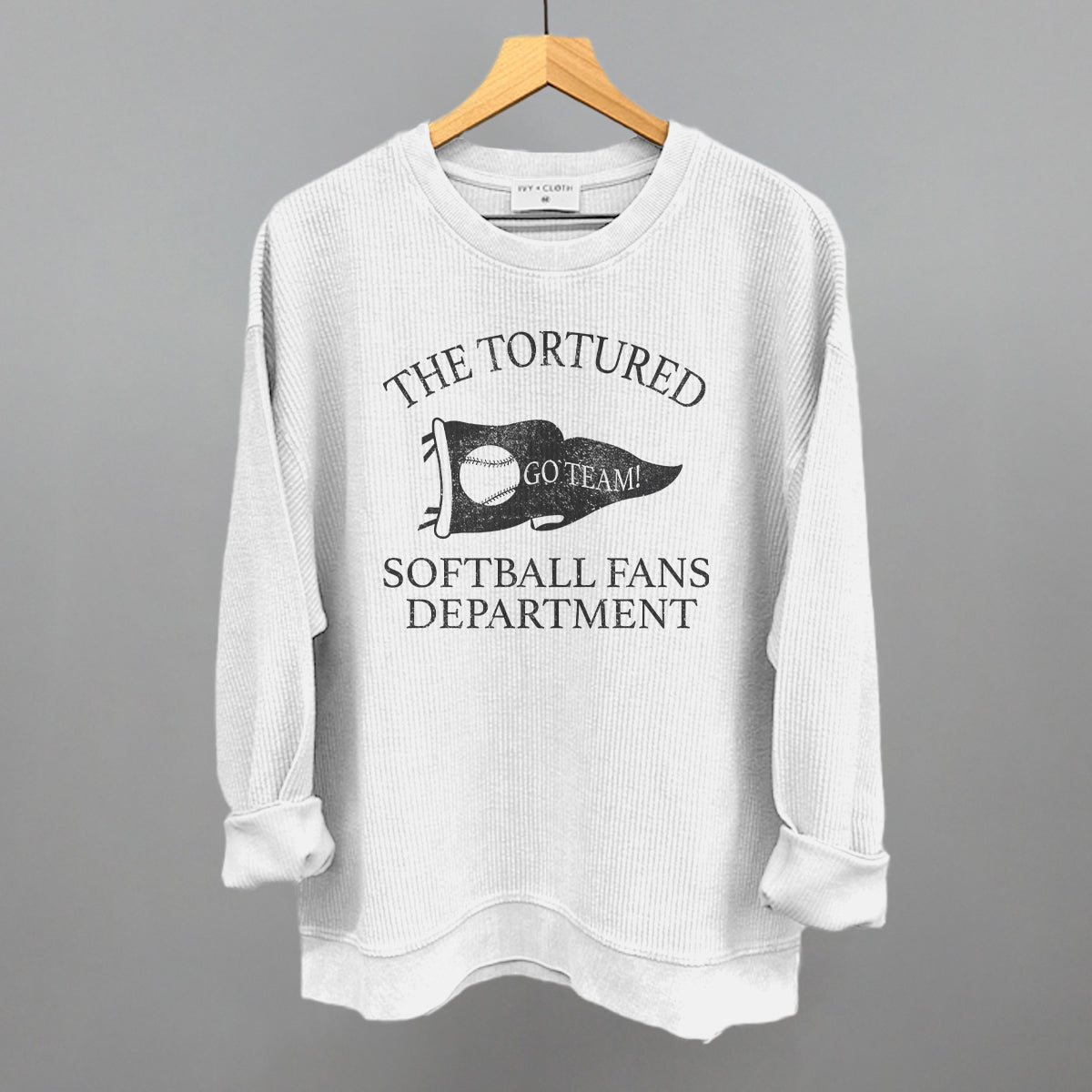 White corded sweatshirt with text that says the tortured Softball fans department 