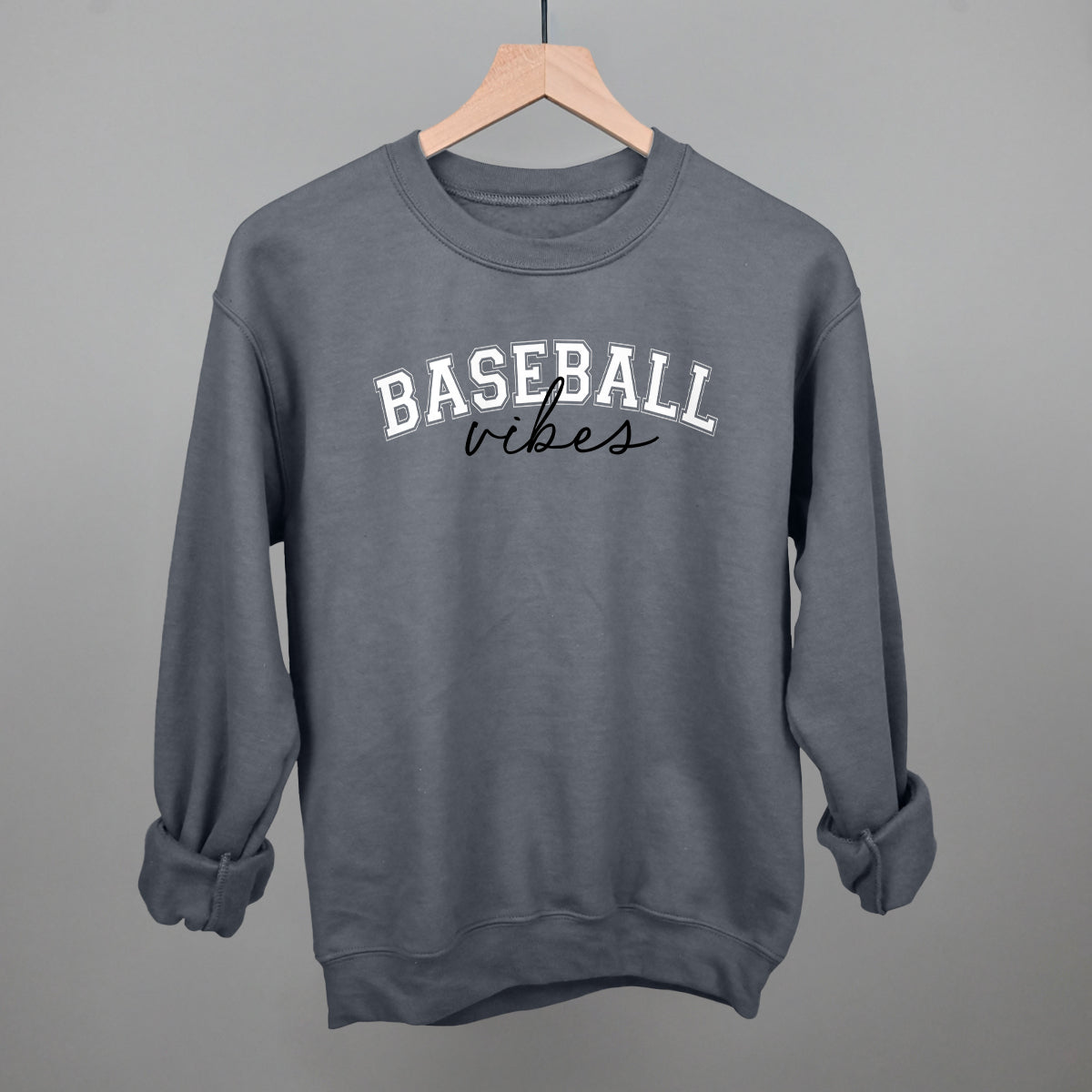 Collection of charcoal sweatshirt with 'BASEBALL vibes' text on a hanger against a gray background in a gallery layout