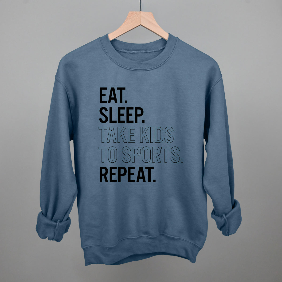 Collection of Blue comfort colors sweatshirt with text on a hanger against a gray background in a gallery layout
