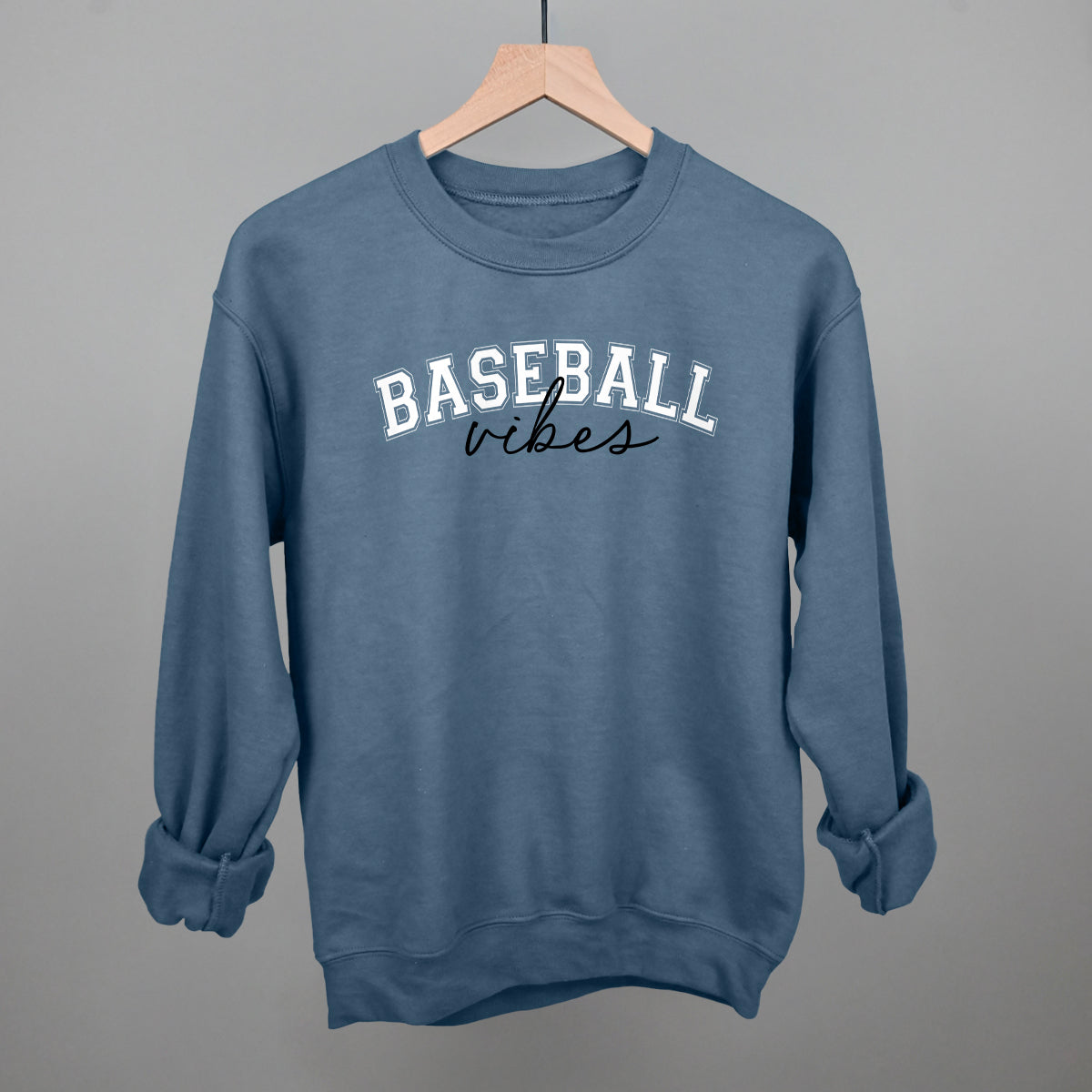 Collection of indigo Blue sweatshirt with 'BASEBALL vibes' text on a gray background in a gallery layout