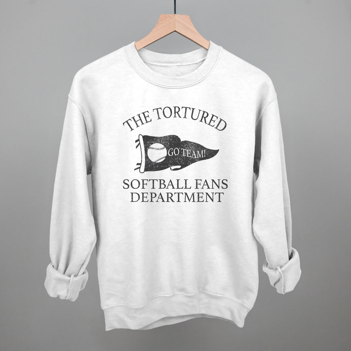 White sweatshirt with black text that says the tortured Softball fans department 