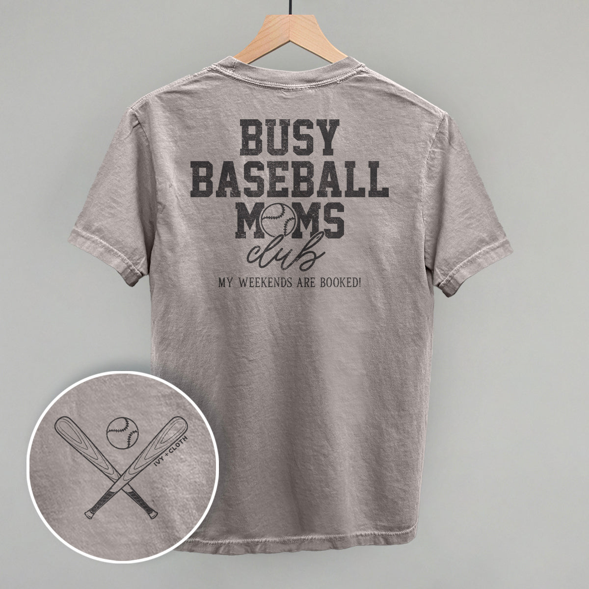 Gray t-shirt with 'Busy Baseball Moms Club' text on a hanger against a gray background