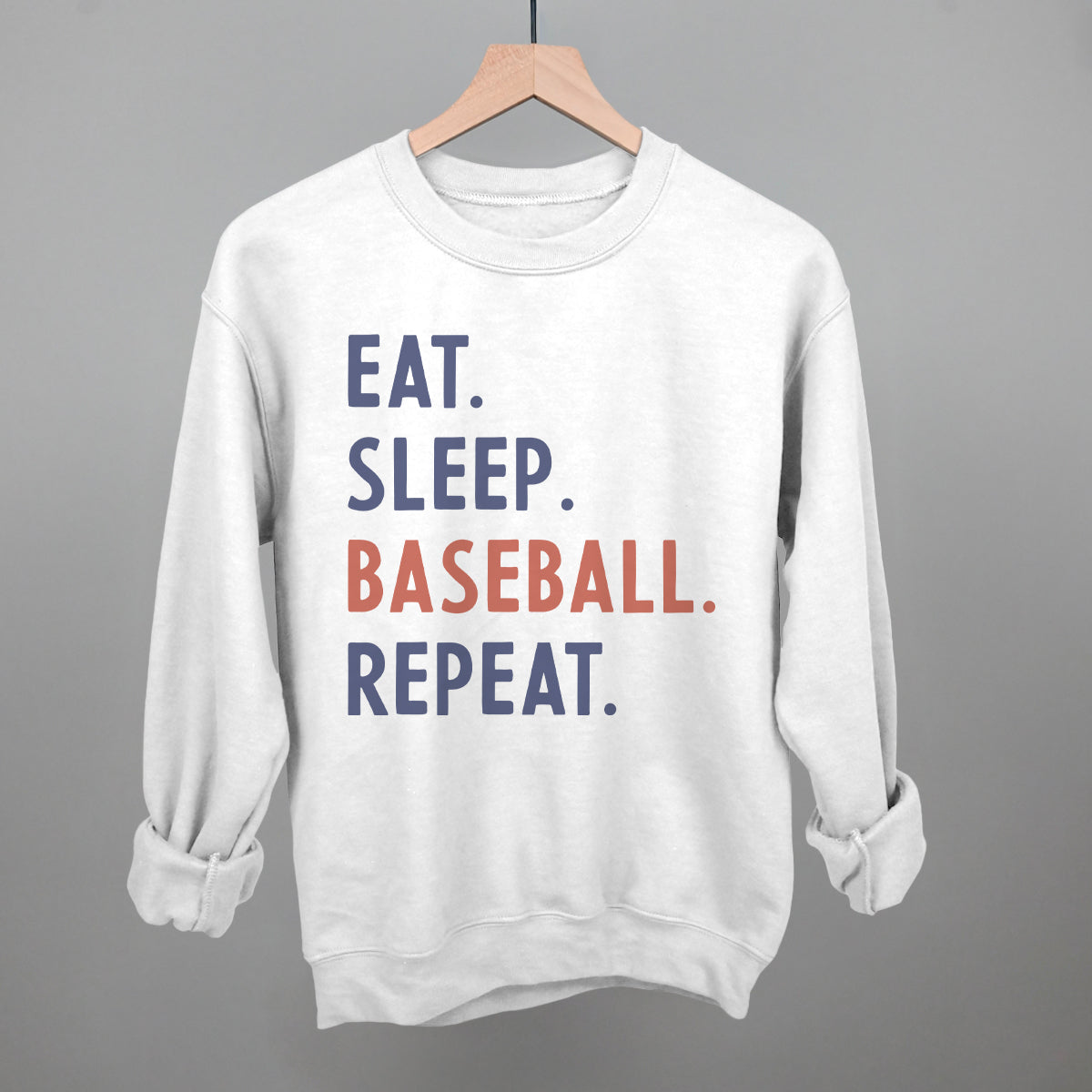 Collection of White sweatshirt with 'EAT. SLEEP. BASEBALL. REPEAT.' text on a gray background in a gallery layout