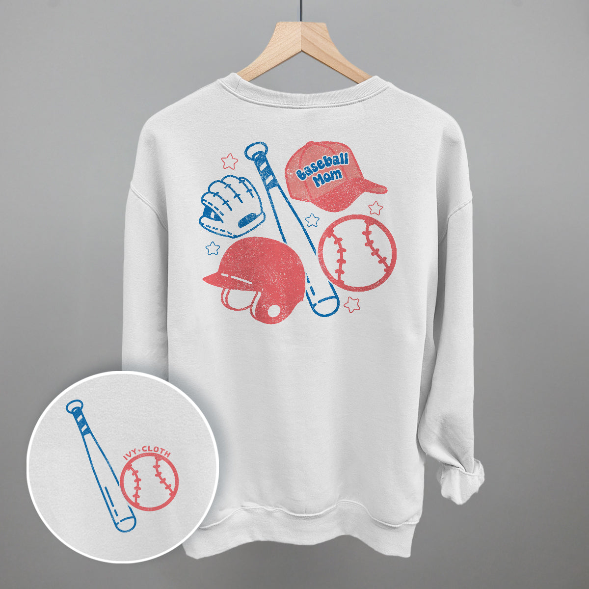 White sweatshirt with baseball-themed graphics on a gray background