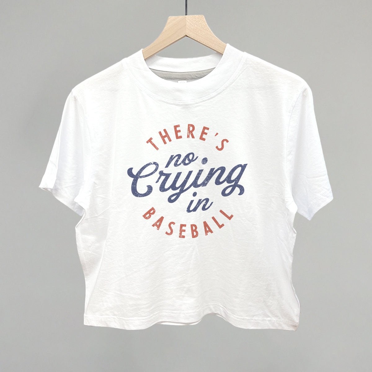 White t-shirt with 'There's no crying in baseball' text on a gray background