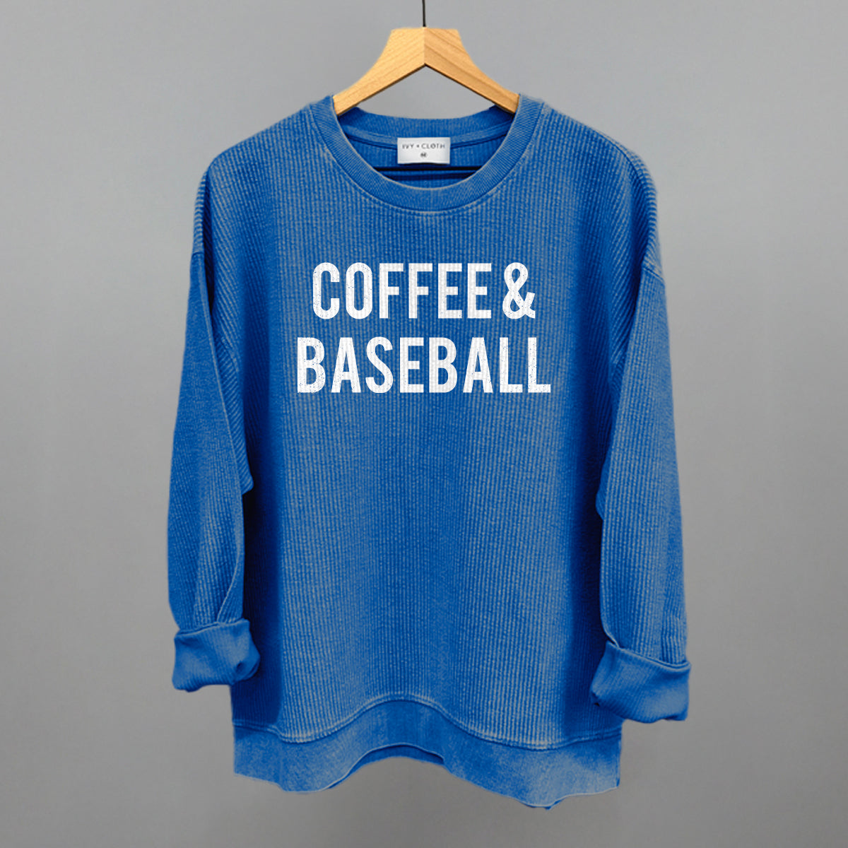 Blue corded crew sweatshirt with 'COFFEE & BASEBALL' text on a gray background