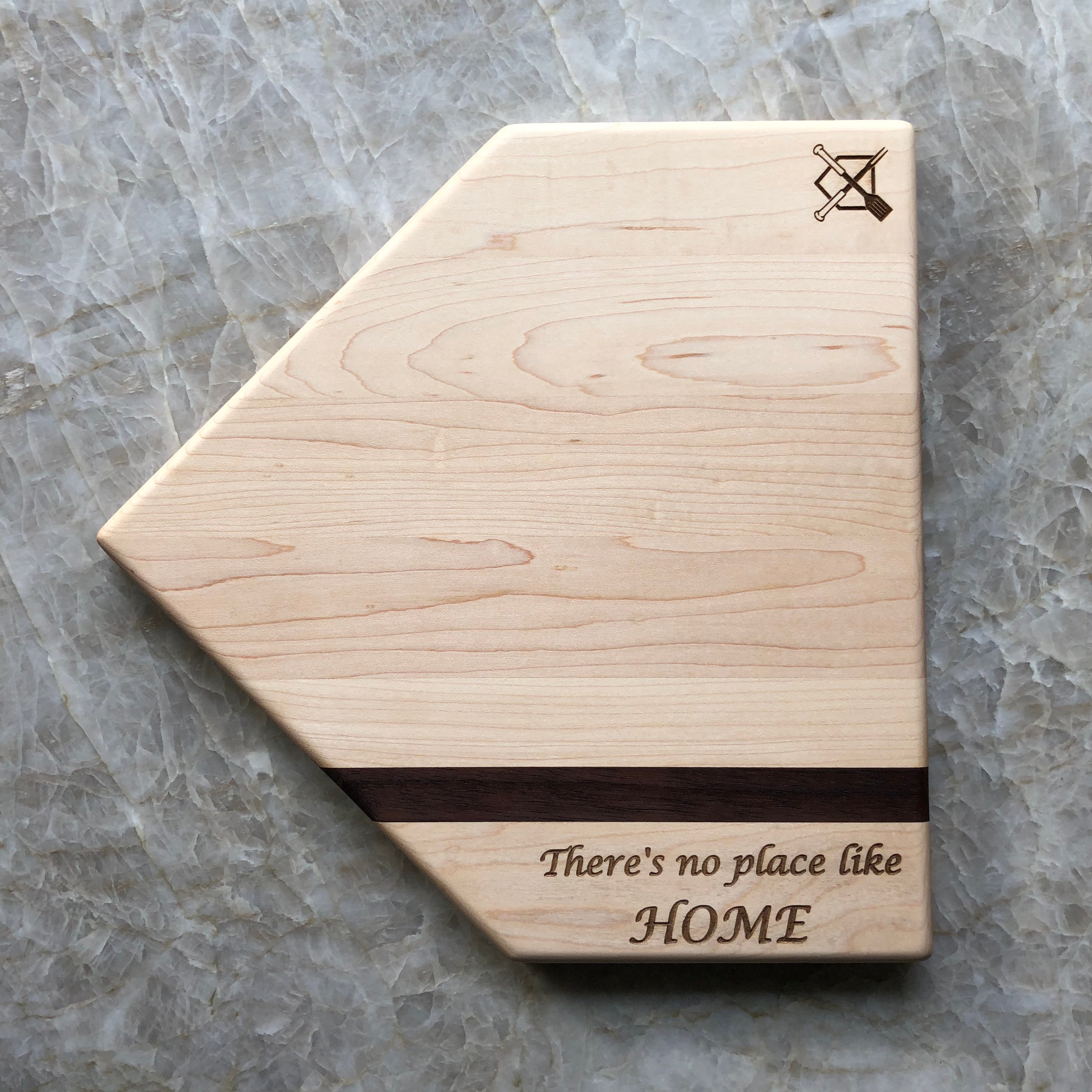 Collection of Wooden cutting board with 'There's no place like HOME' engraving on a marble surface in a gallery layout
