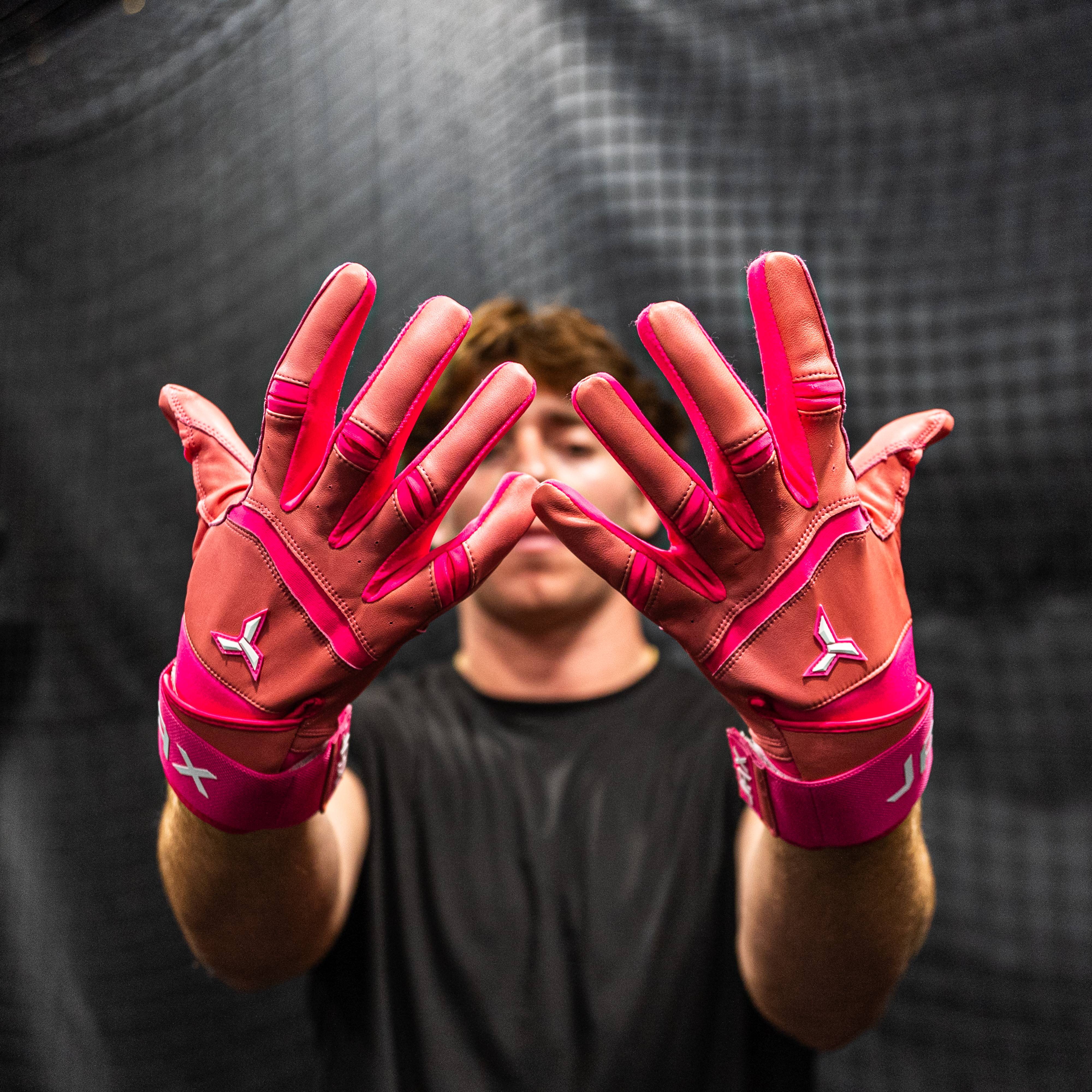 Collection of Person wearing pink JAX batting gloves with a blurred background in a gallery layout