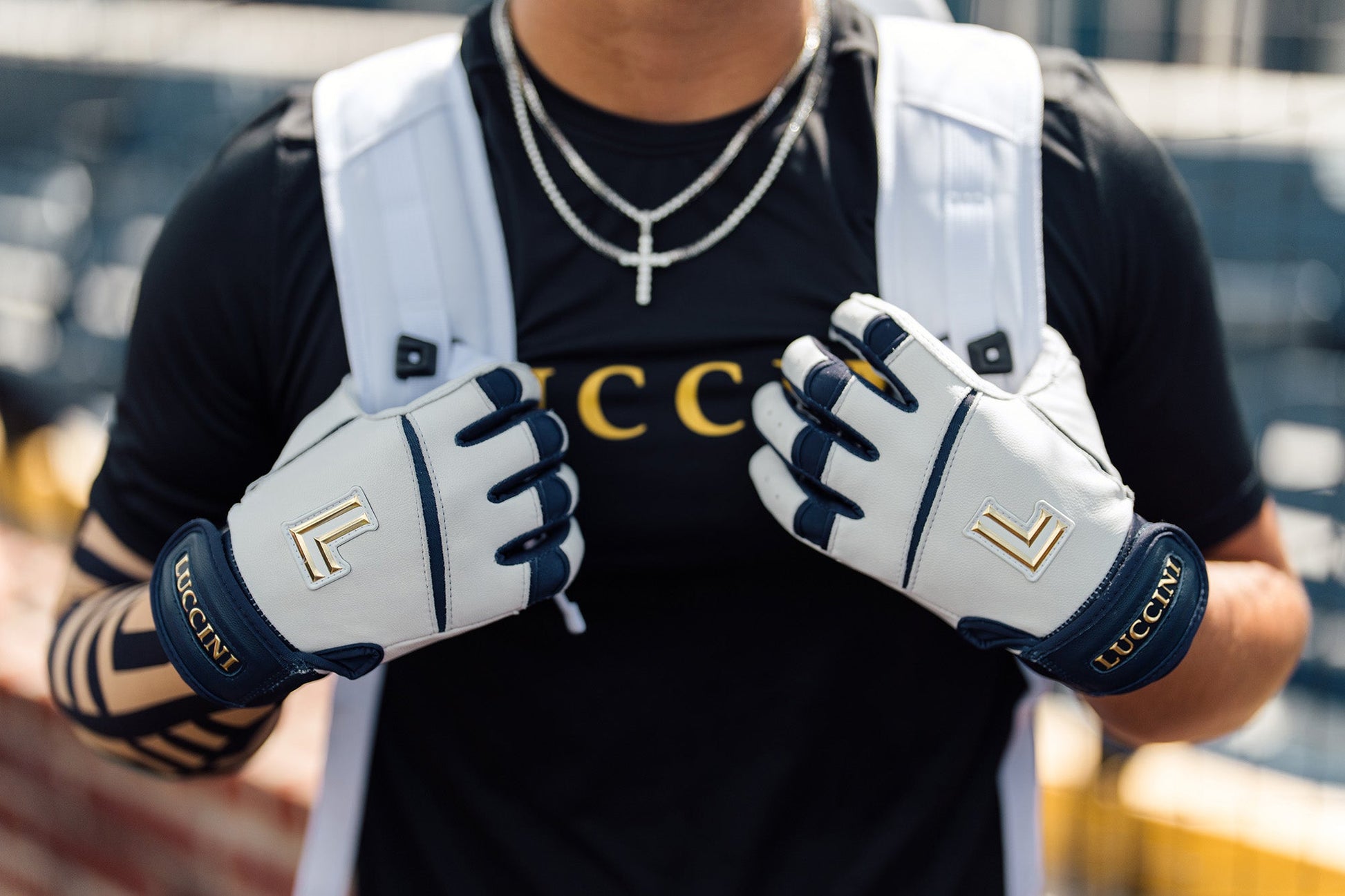 Person wearing white gloves with blue accents and 'LCC' branding, holding hands together.