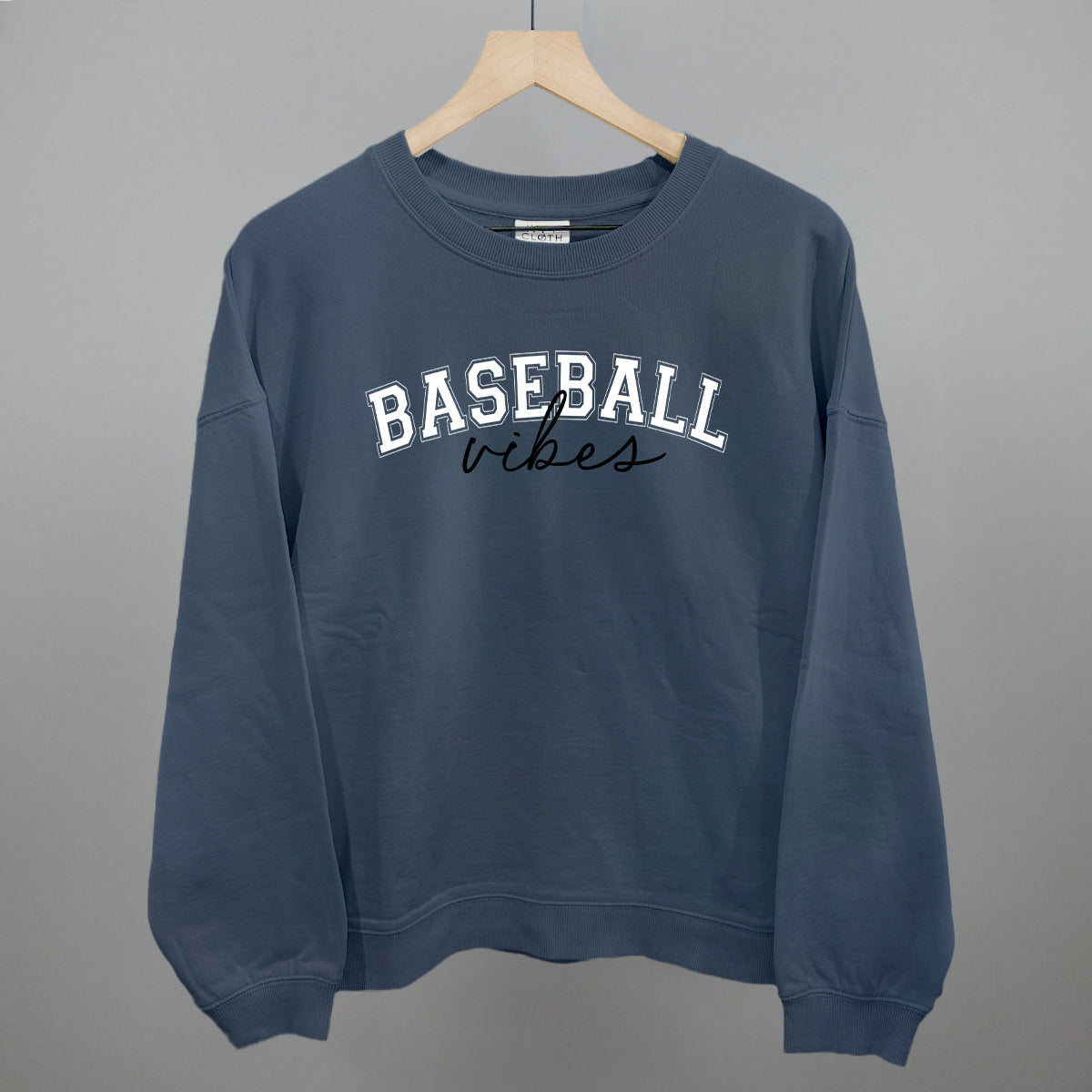 Navy blue sweatshirt with 'BASEBALL vibes' text on a gray background