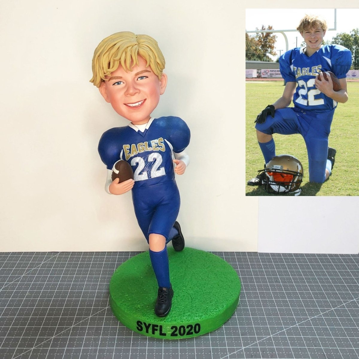 Collection of Bobblehead of a boy in a blue football uniform with a photo of the same boy on a field. in a gallery layout
