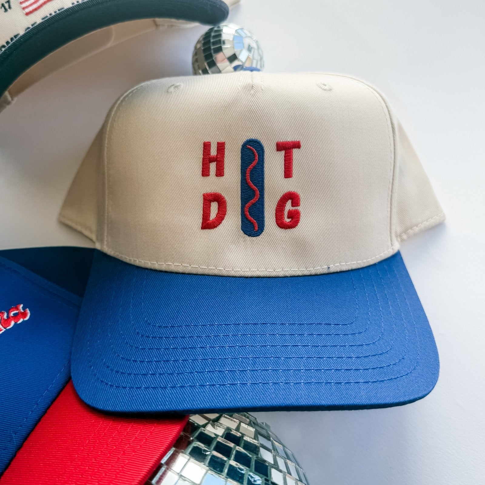 Beige cap with 'HOT DoG' text on a white background