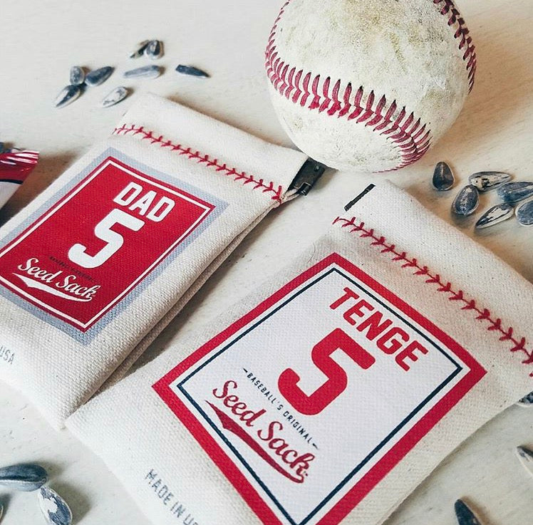 Collection of Two seed sacks with baseball design and text, accompanied by a baseball on a light background. in a gallery layout