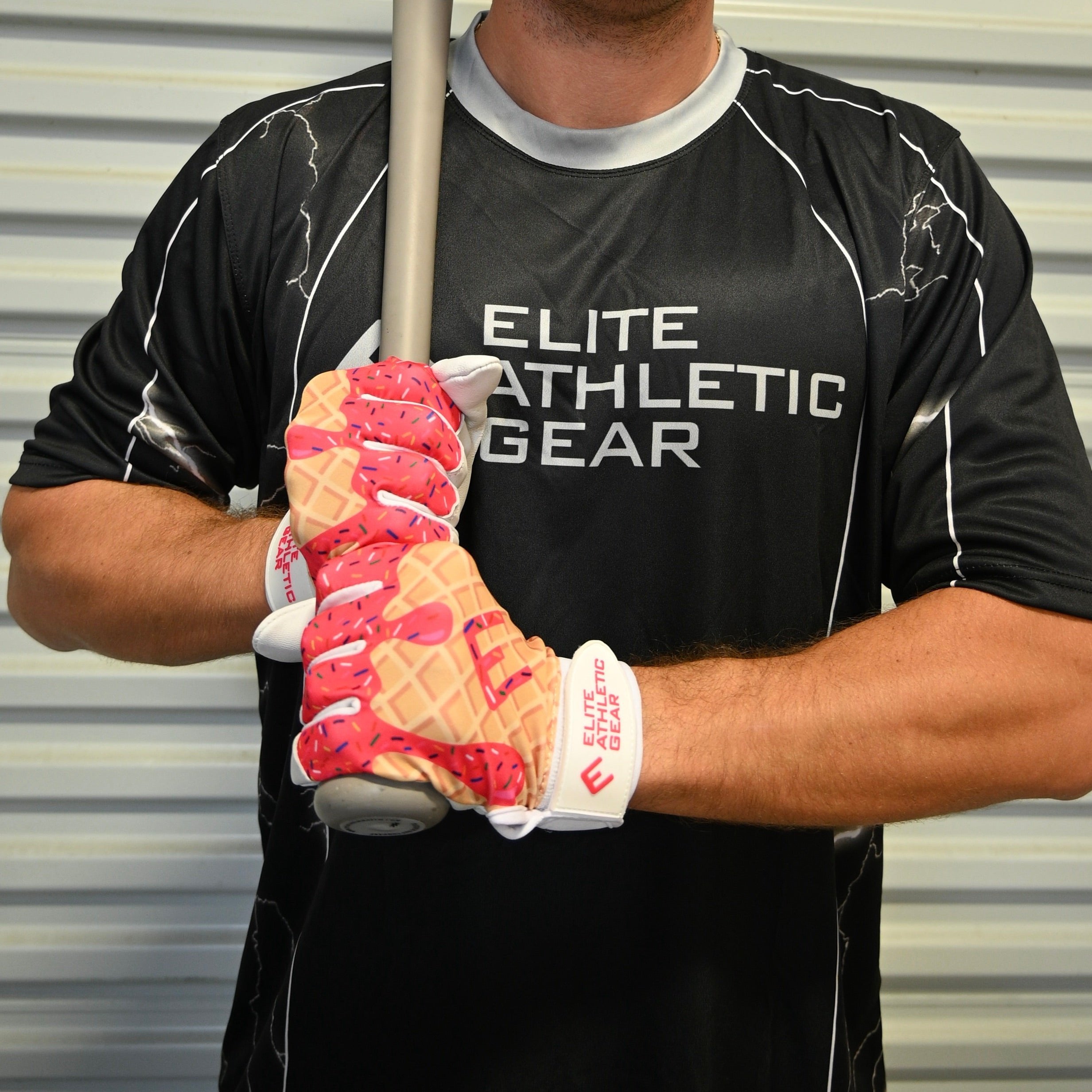 Collection of Person wearing a black 'Elite Athletic Gear' shirt holding a baseball bat with pink and white ice cream drip batting gloves in a gallery layout