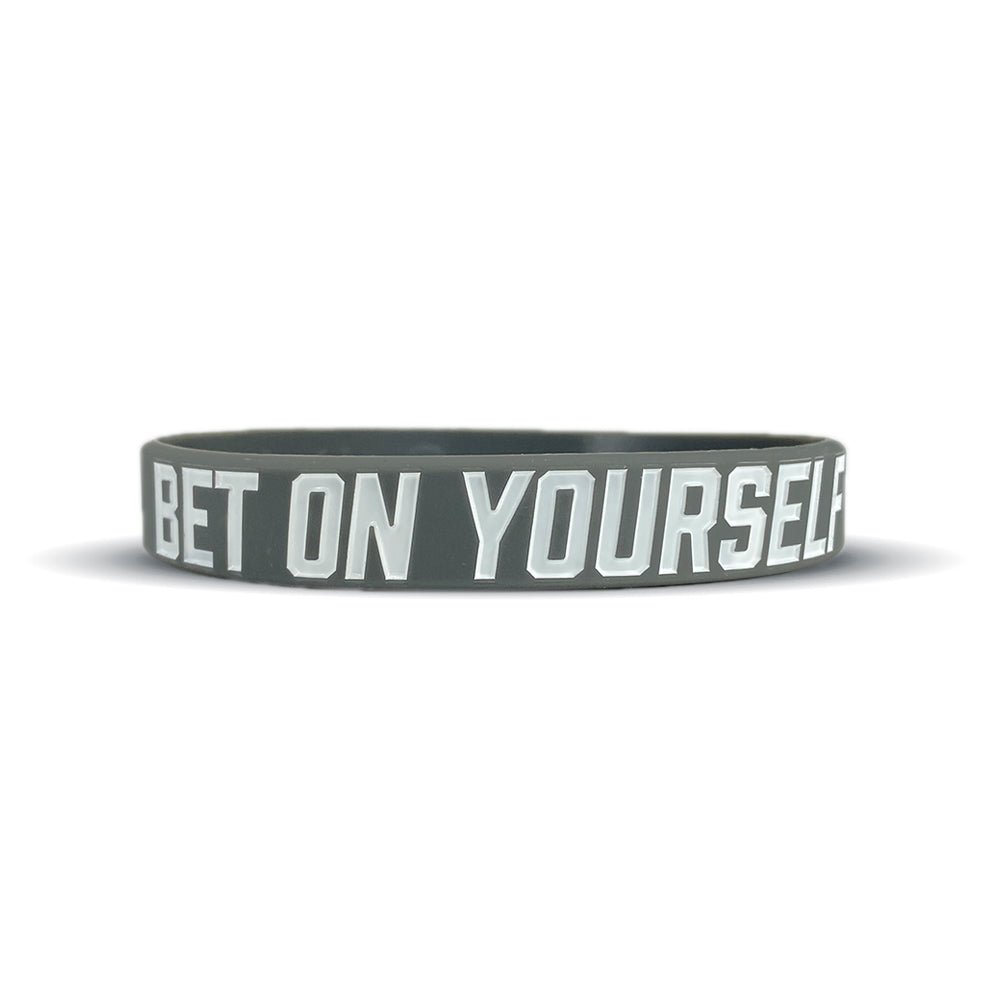 Black wristband with 'BET ON YOURSELF' text on a white background
