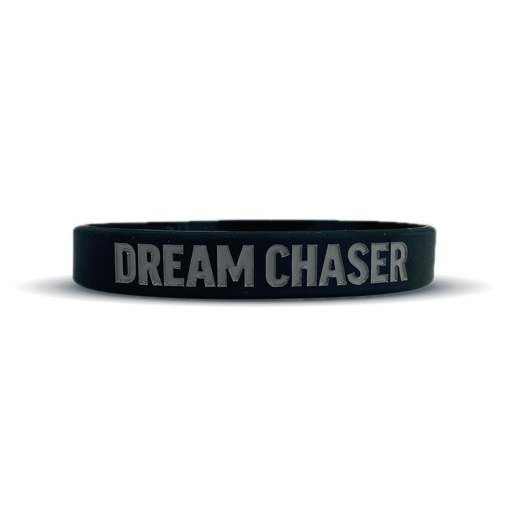 Black wristband with 'DREAM CHASER' text on a white background