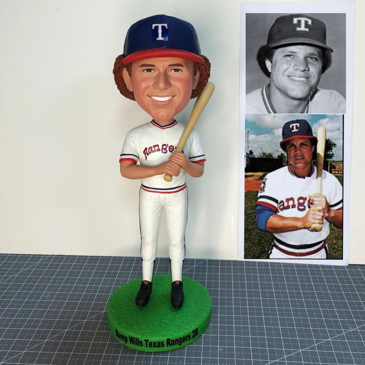 Collection of Bobblehead of a baseball player in Texas Rangers uniform with a photo of the player on the right. in a gallery layout