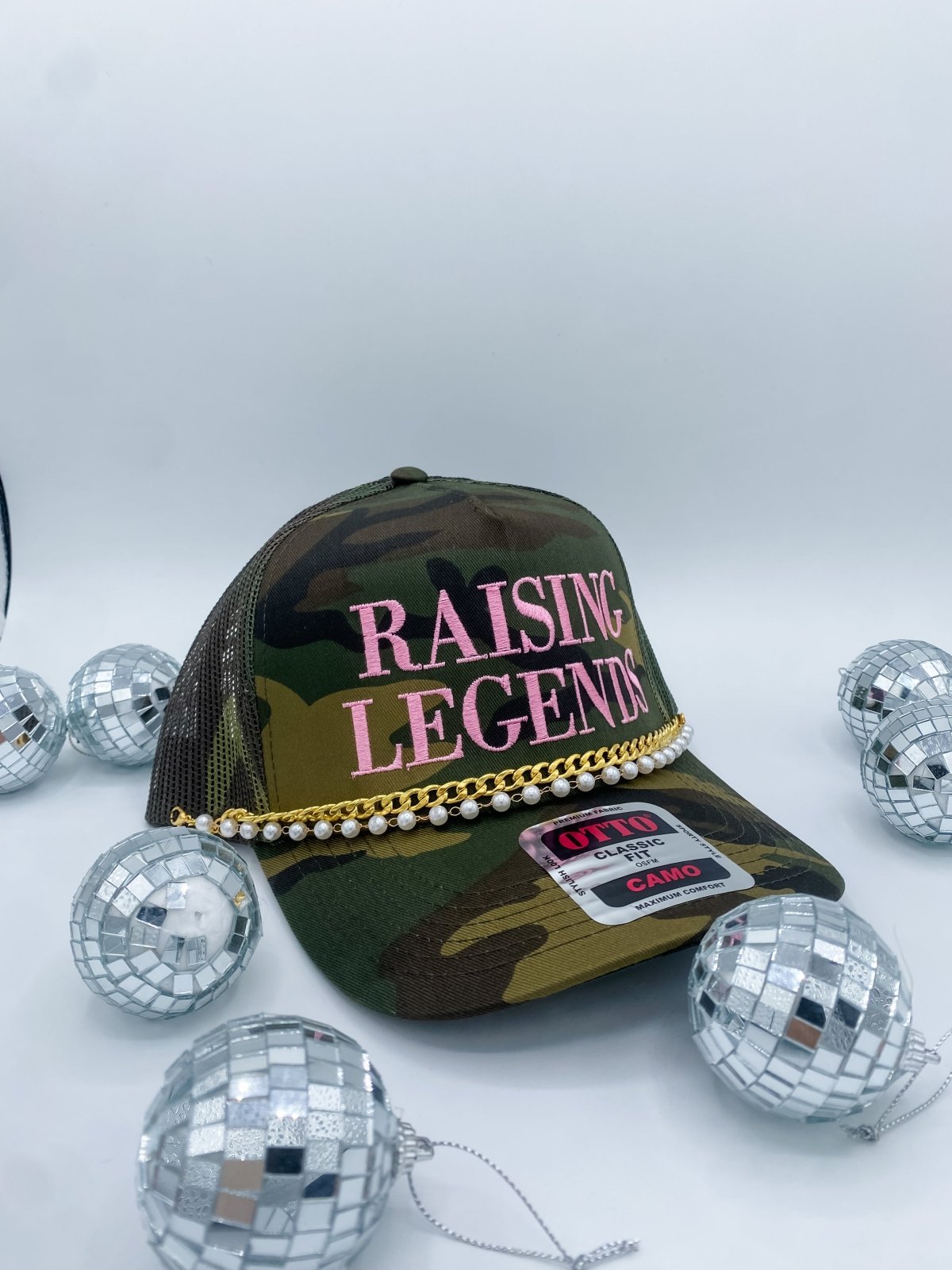 Collection of Camouflage cap with 'RAISING LEGENDS' text and disco balls on a white background in a gallery layout